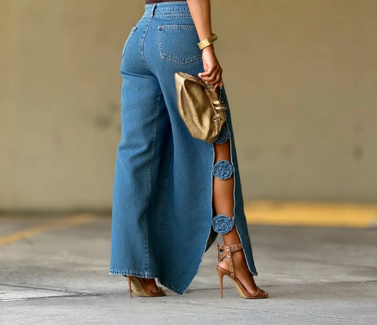 Women's blue wide-leg jeans with 3D floral side split detail, back and side view styled with gold heeled sandals
