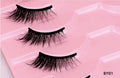 Three pairs of black false eyelashes arranged in a pink plastic tray, with the text 'BY01' in the bottom right corner.