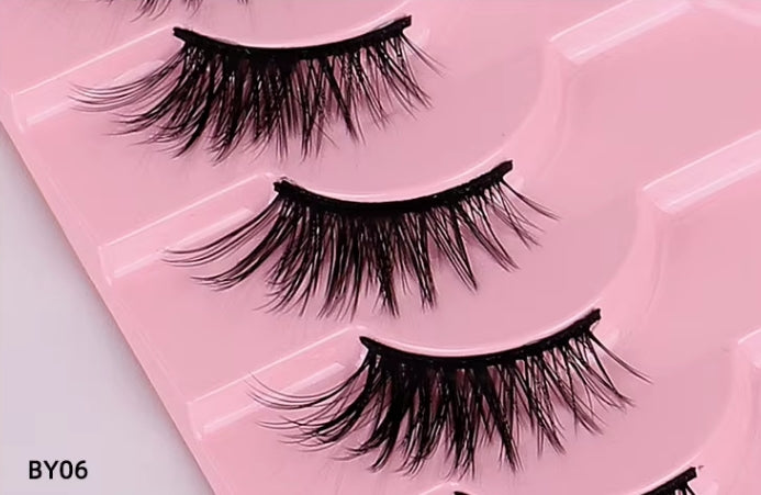 Three pairs of black false eyelashes arranged in a pink tray, with the text 'BY06' in the bottom-left corner.