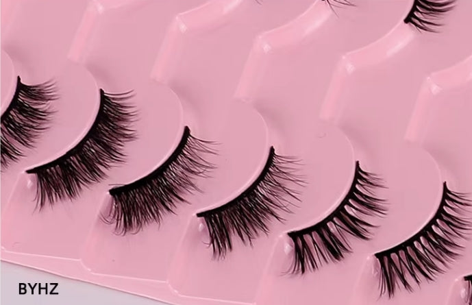 Black false eyelashes arranged in a row on a pink molded tray, with a small BYHZ logo in the lower-left corner.