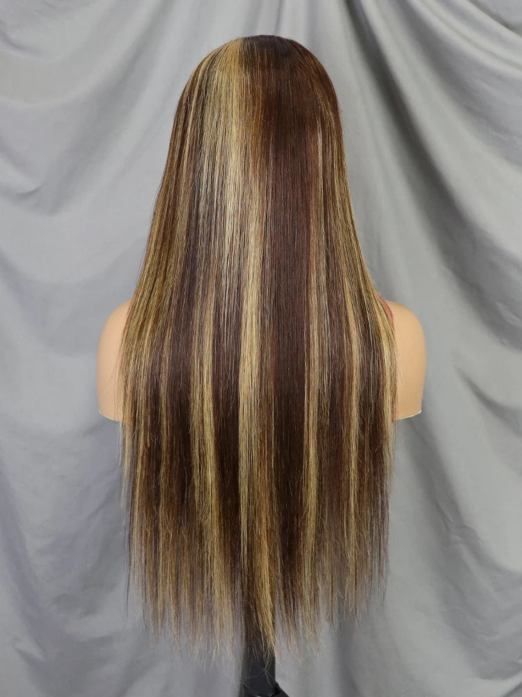 Long, straight wig displayed on a mannequin head from the back, featuring dark brown roots with warm caramel and honey blonde highlights running through the length, set against a draped gray fabric backdrop.