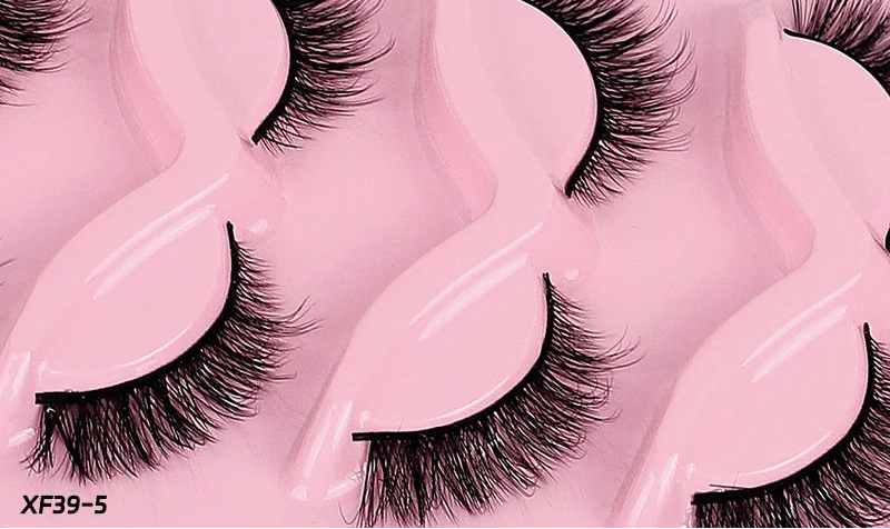False eyelashes with pink holder and text 'Oblique flight 5 pairs' on a close-up of eyes.