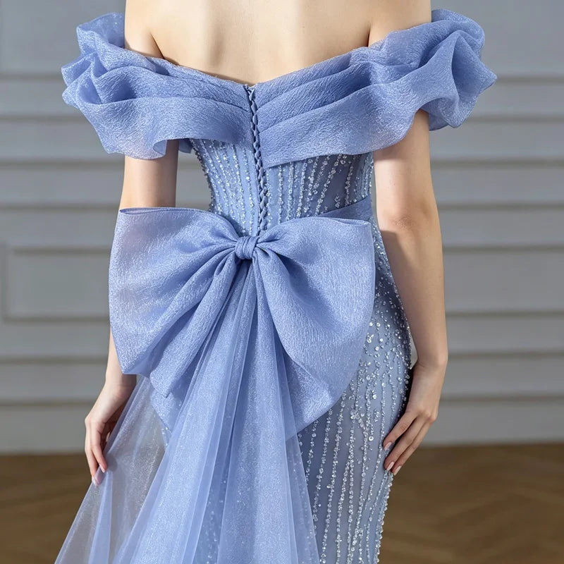 Close-up of oversized bow back detail and beaded sequined bodice on light blue mermaid evening gown

