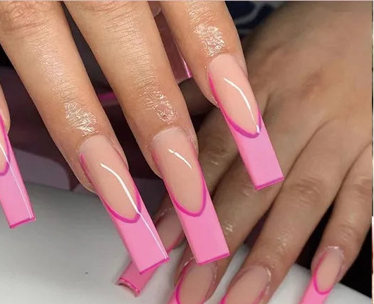 A hand wearing long square press-on nails with a pink-to-peach gradient and a bright pink curved accent line, alongside a sheet preview of the nail design and the text '#JP1731'.