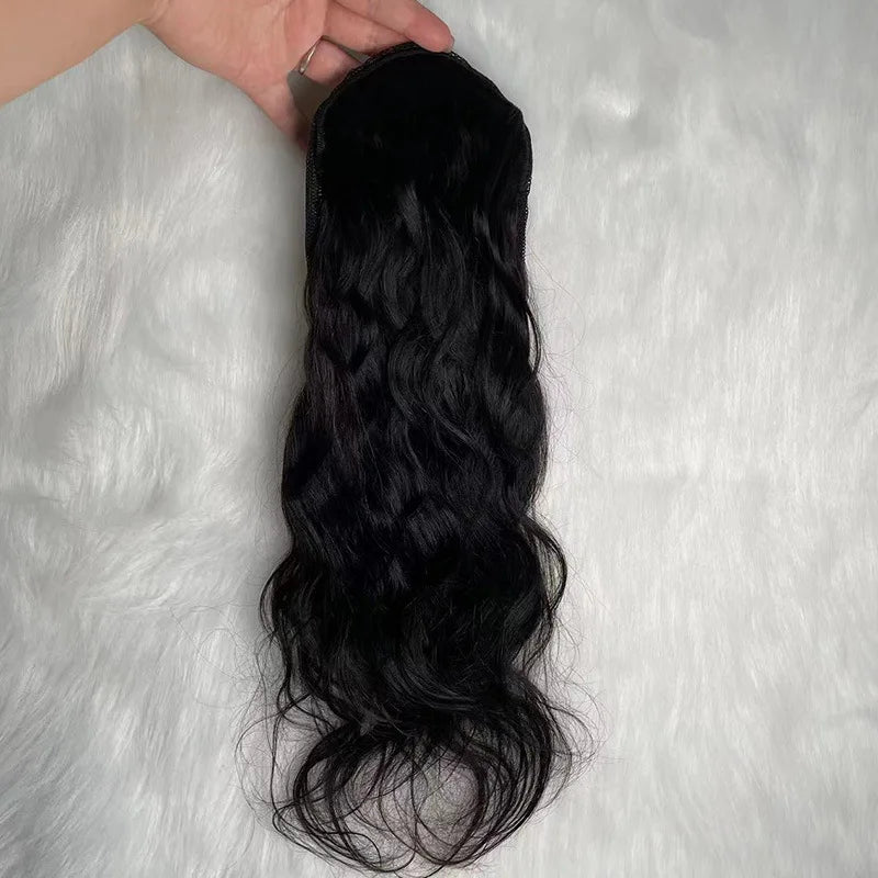 Image 4 — Black body wave human hair drawstring ponytail held by hand showing full length and wave texture
