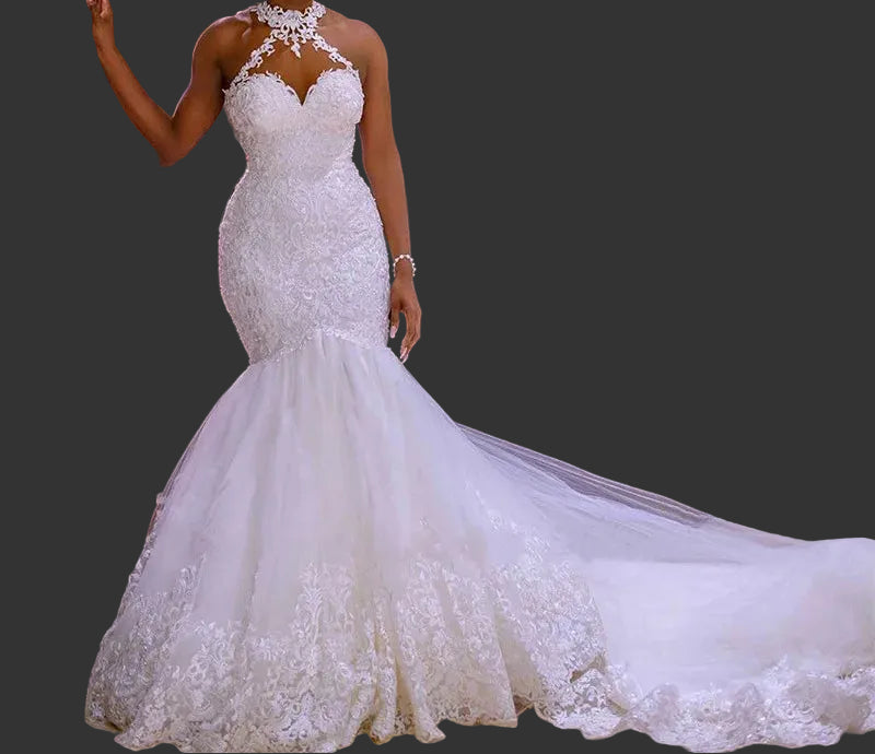 White halter neck lace mermaid wedding dress with beaded sweetheart bodice and cathedral train, front view on dark background

