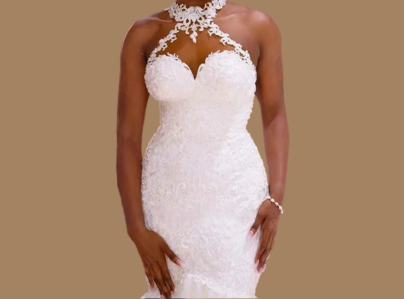  Close-up of sheer lace halter collar and beaded sweetheart neckline on white mermaid wedding dress, tan background

