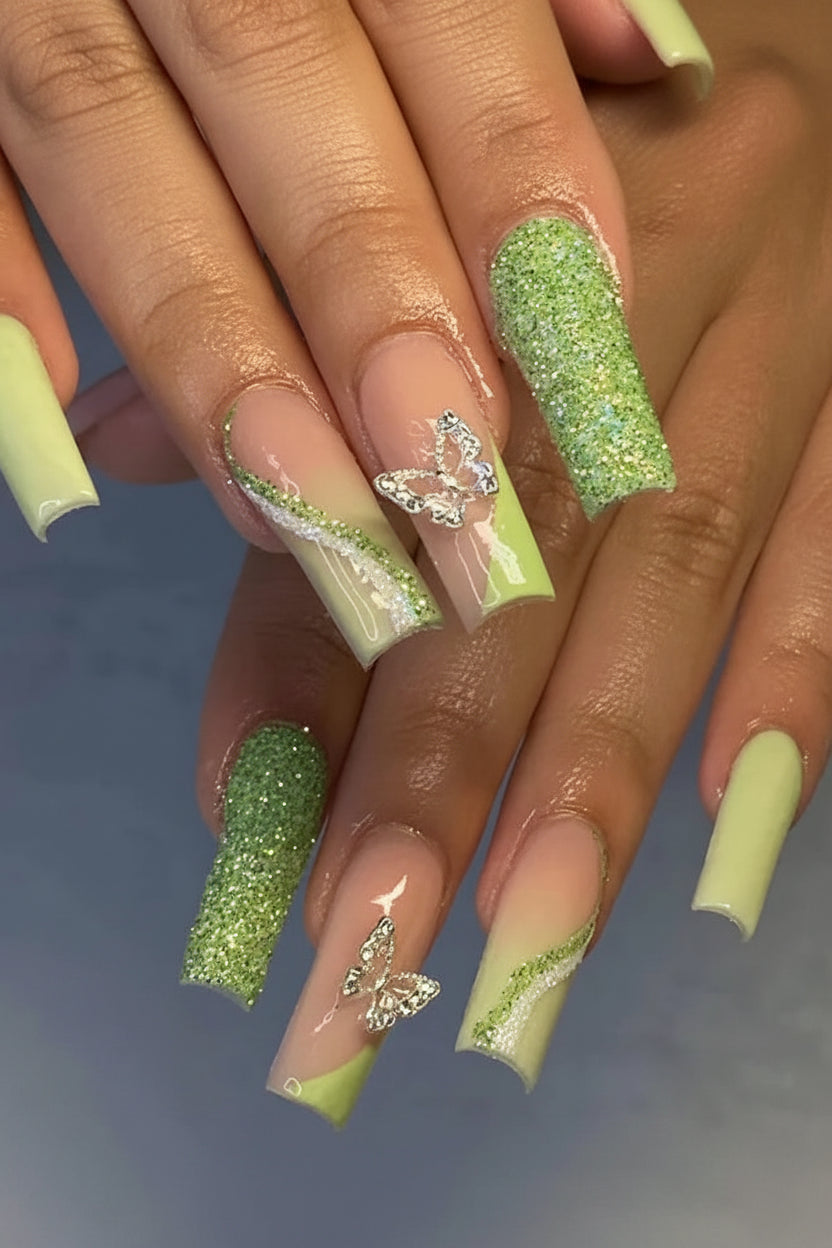 A collage showing a hand with long coffin-shaped press-on nails in a pastel peach-to-lime green gradient with glitter green tips and a rhinestone accent, alongside a sheet of matching nail tips and the text #JP2380.
