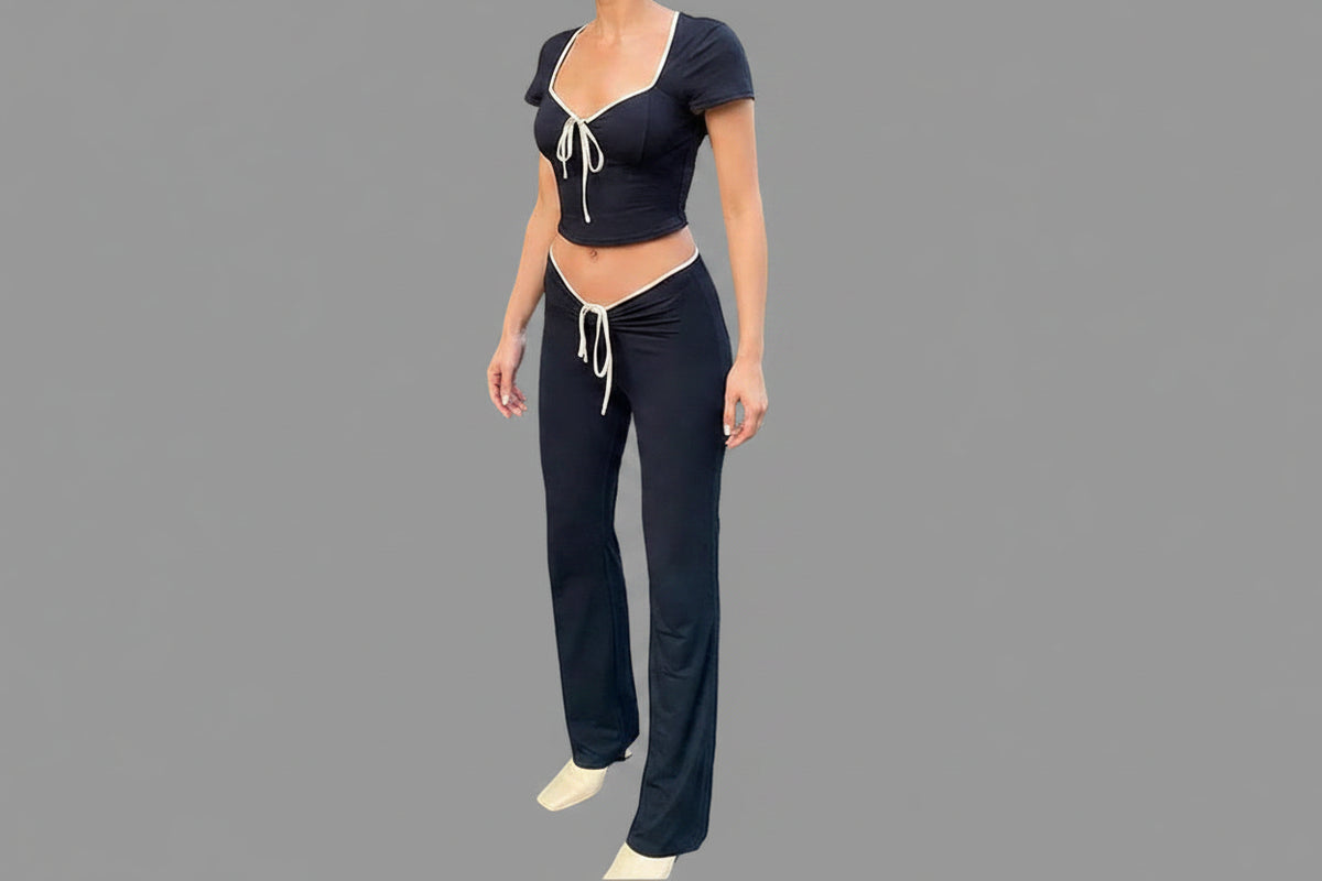 Black square neck short sleeve crop top and flare pants with cream contrast trim — side angle view