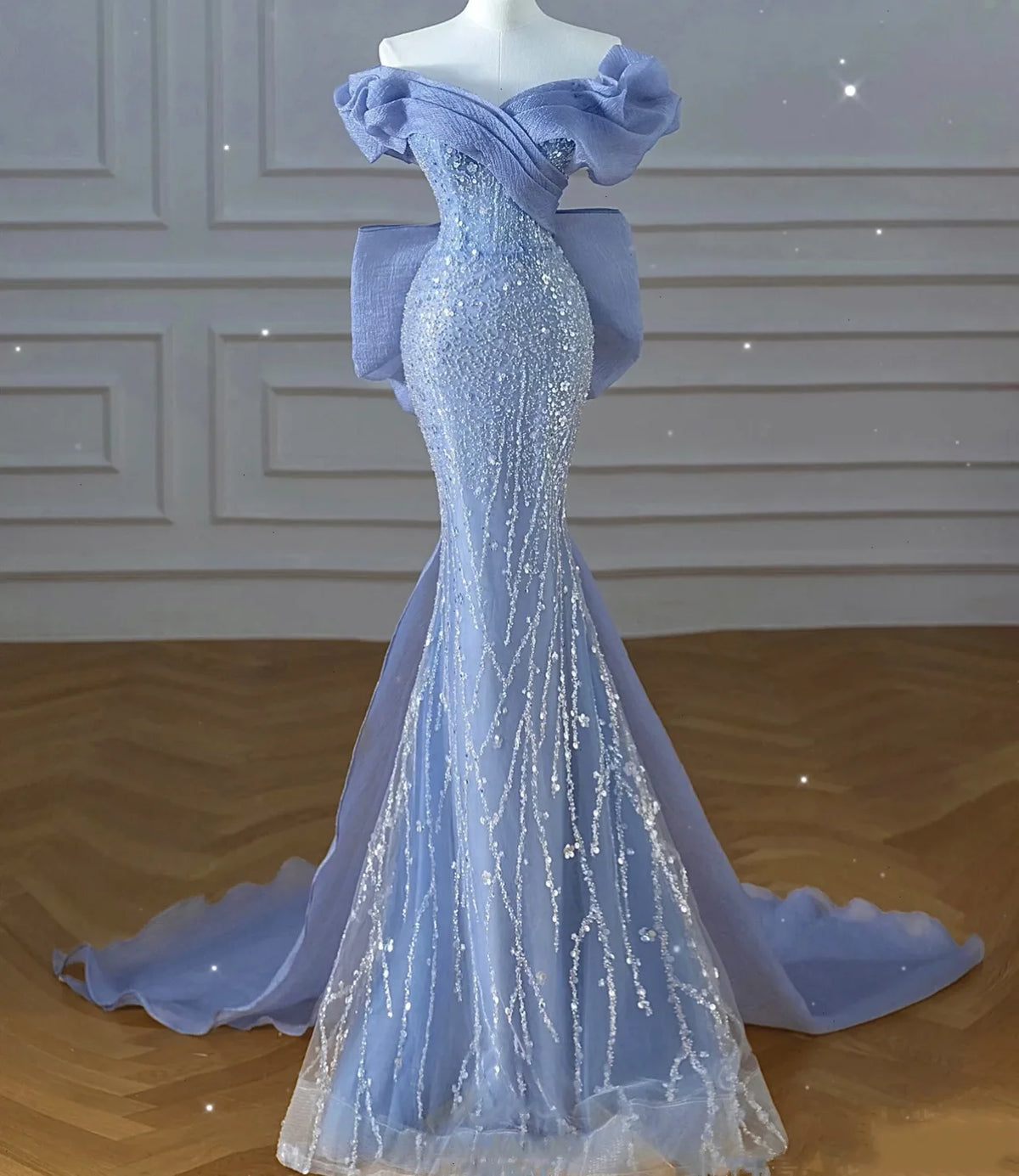 Light blue sequined beaded mermaid gown with off-shoulder ruffled sleeves and cathedral train, full length back view