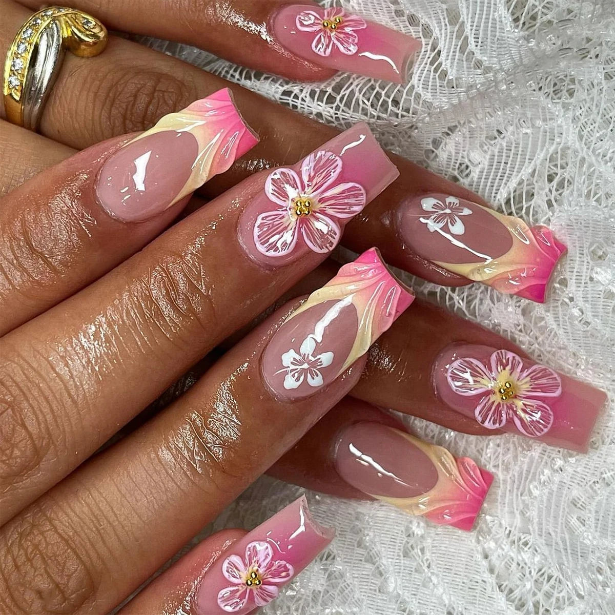 Nails with floral design on a textured white background
