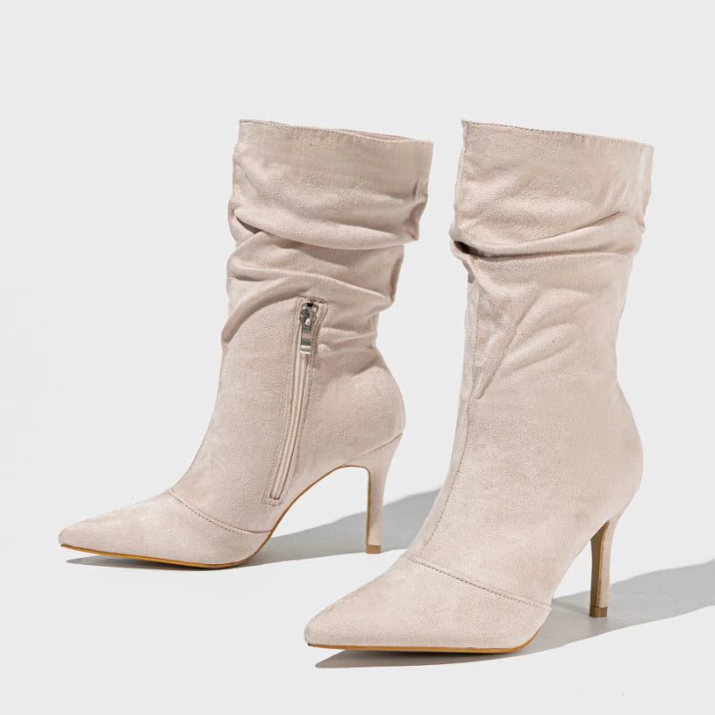 Beige knee-high boots with a zipper on a light gray background