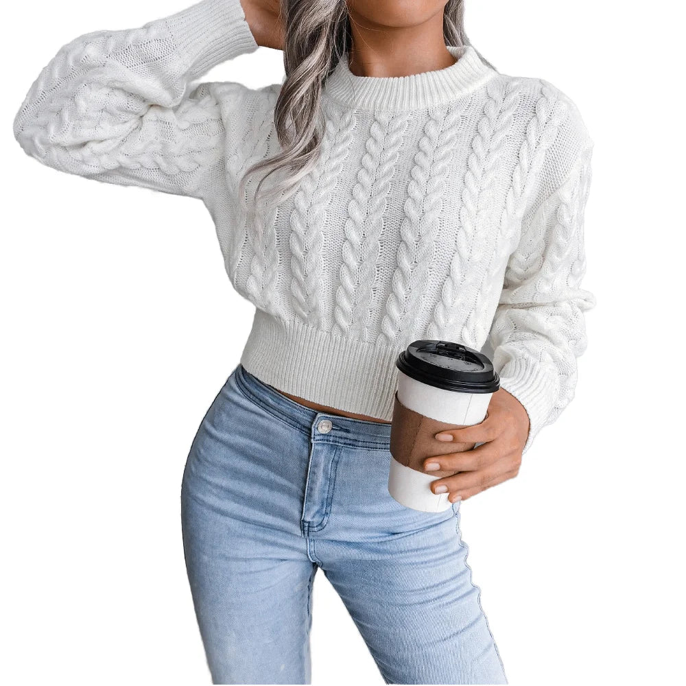 Women's white cable knit crew neck pullover sweater styled with high-waist jeans