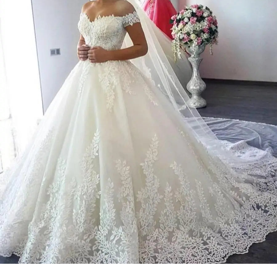 Elegant lace ball gown wedding dress with sweetheart neckline and court train