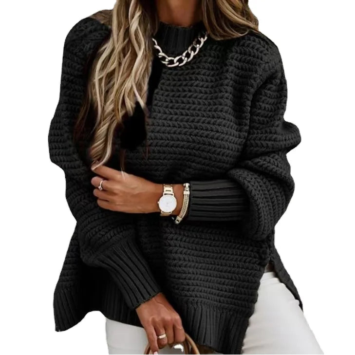 Person wearing a black knitted sweater with a white background
