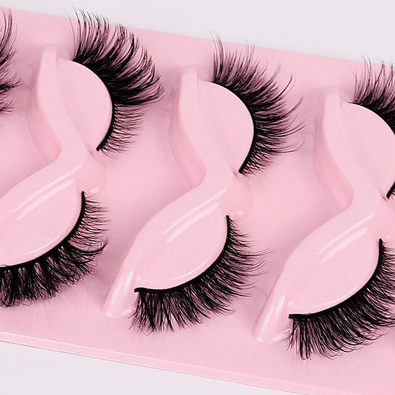 Set of false eyelashes in a pink tray on a white background