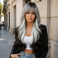Long wavy gray and black highlight synthetic wig with soft curtain bangs, 26 inch, worn by model outdoors