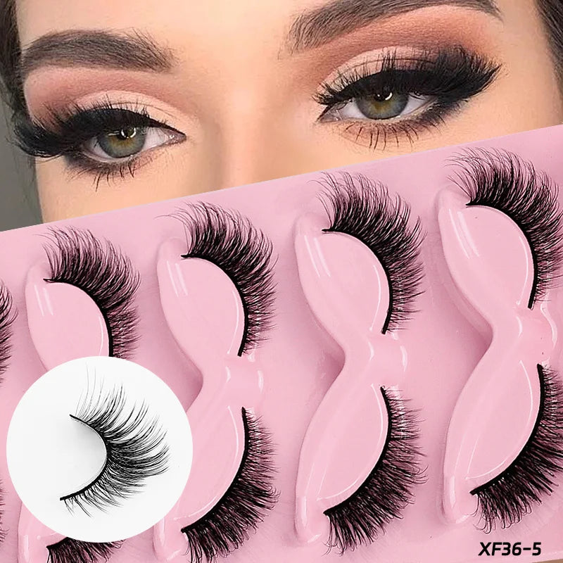 False eyelashes displayed on a pink tray with a close-up of a woman's eyes wearing them.