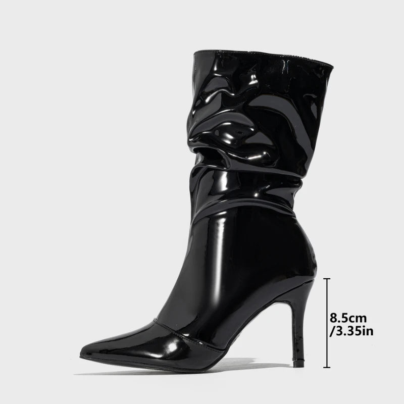 Black patent leather boot with high heel on a white background