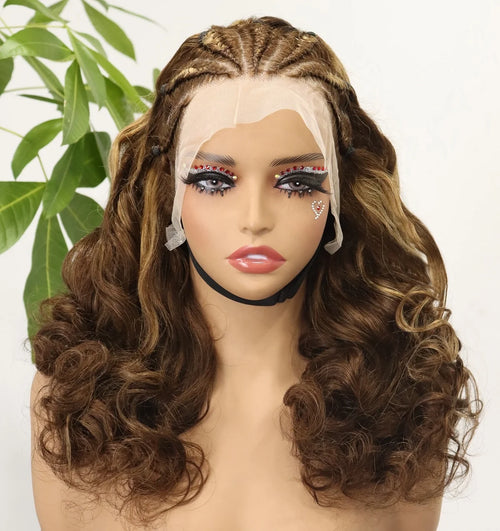 A brown lace front wig with long, wavy curls and subtle blonde highlights, displayed on a mannequin head against a white background with a green plant leaf in the corner.