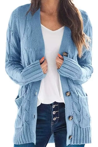 A woman wearing a light blue cable-knit open-front cardigan with front pockets over a white top and dark blue jeans, shown from the shoulders to the upper thighs on a plain white background.