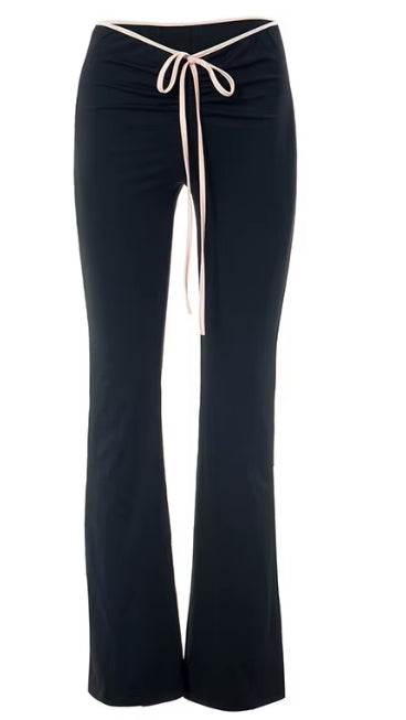 Black flared pants with a cream-colored drawstring waistband, shown against a plain white background.