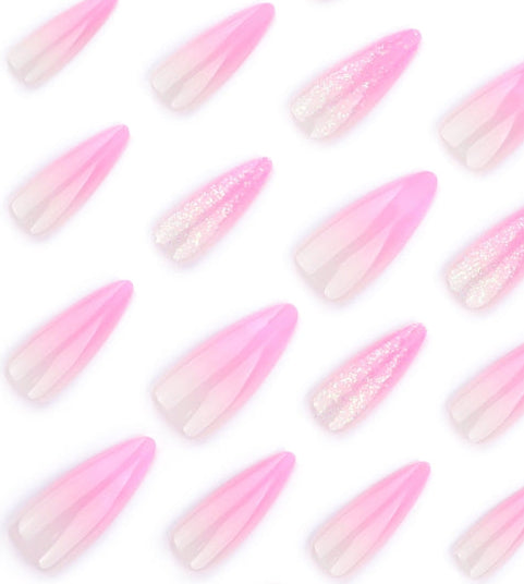 Pink gradient coffin-shaped press-on nails with glitter accents, arranged in a repeating pattern on a white background.
